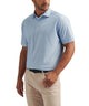 Sailor blue geo-print mesh polo shirt on model with short sleeves and buttoned placket.