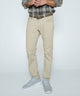 Light khaki stretch denim jeans with straight legs and belt loops, front view.