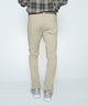 Light khaki stretch denim jeans, back view with belt loops and five-pocket styling.