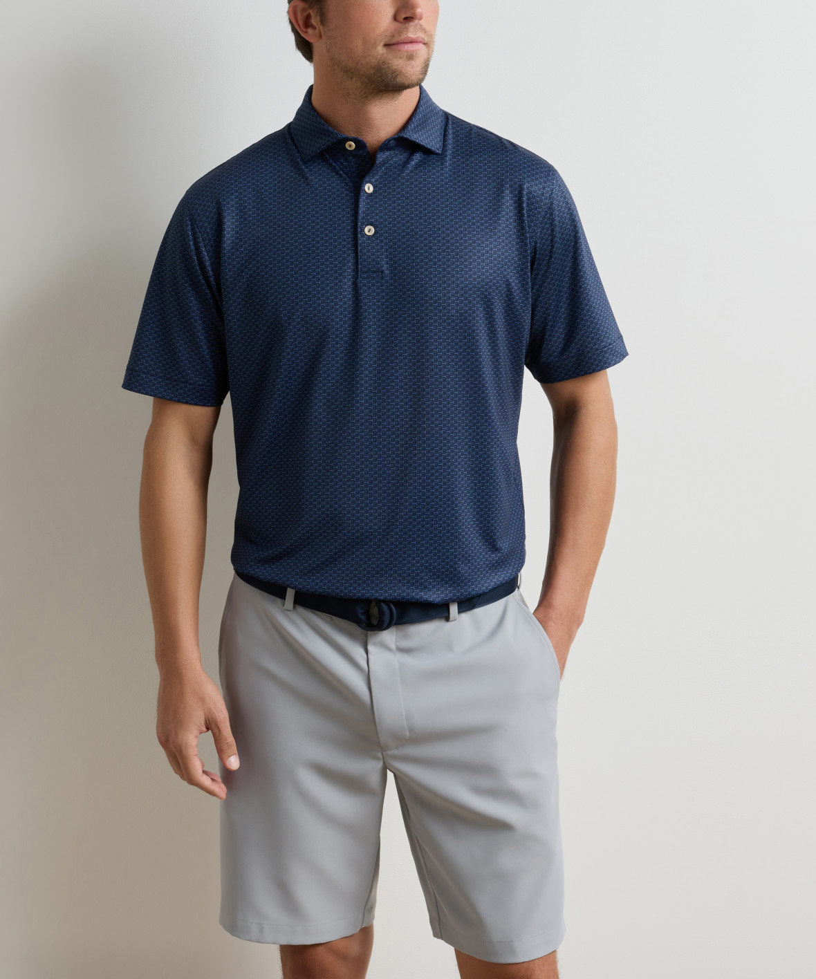 Navy short-sleeve performance polo with patterned print, worn with light shorts, Peter Millar Men's Big & Tall