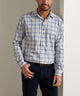 Men's long-sleeve performance flannel shirt in light grey-blue plaid, button-front.