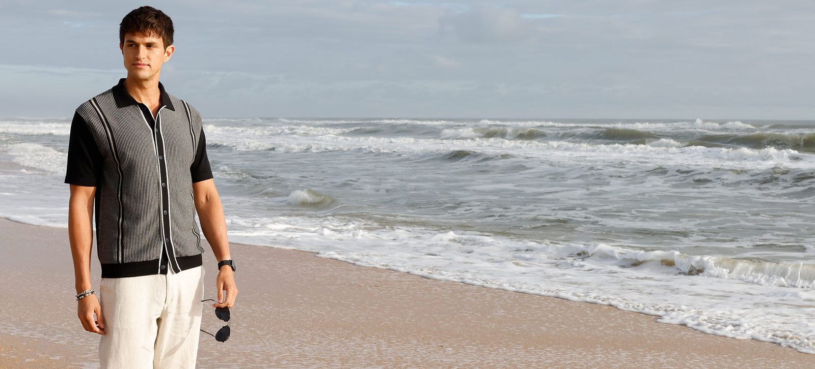 Male model wearing Westport Black Short Sleeve Como Button Front Polo